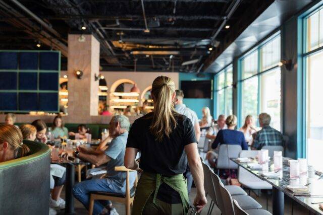 Waitress working in a busy restaurant