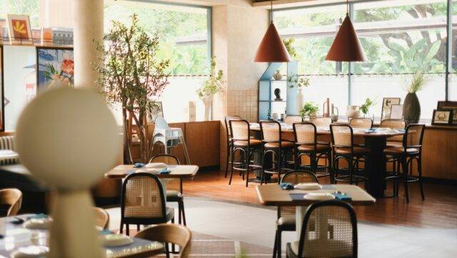 Restaurant decorated in modern decor with plants and miniature sculptures